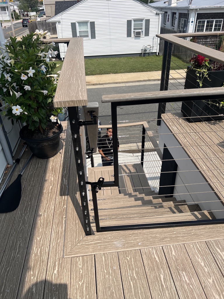 Close view of outdoor deck railing and stairs.